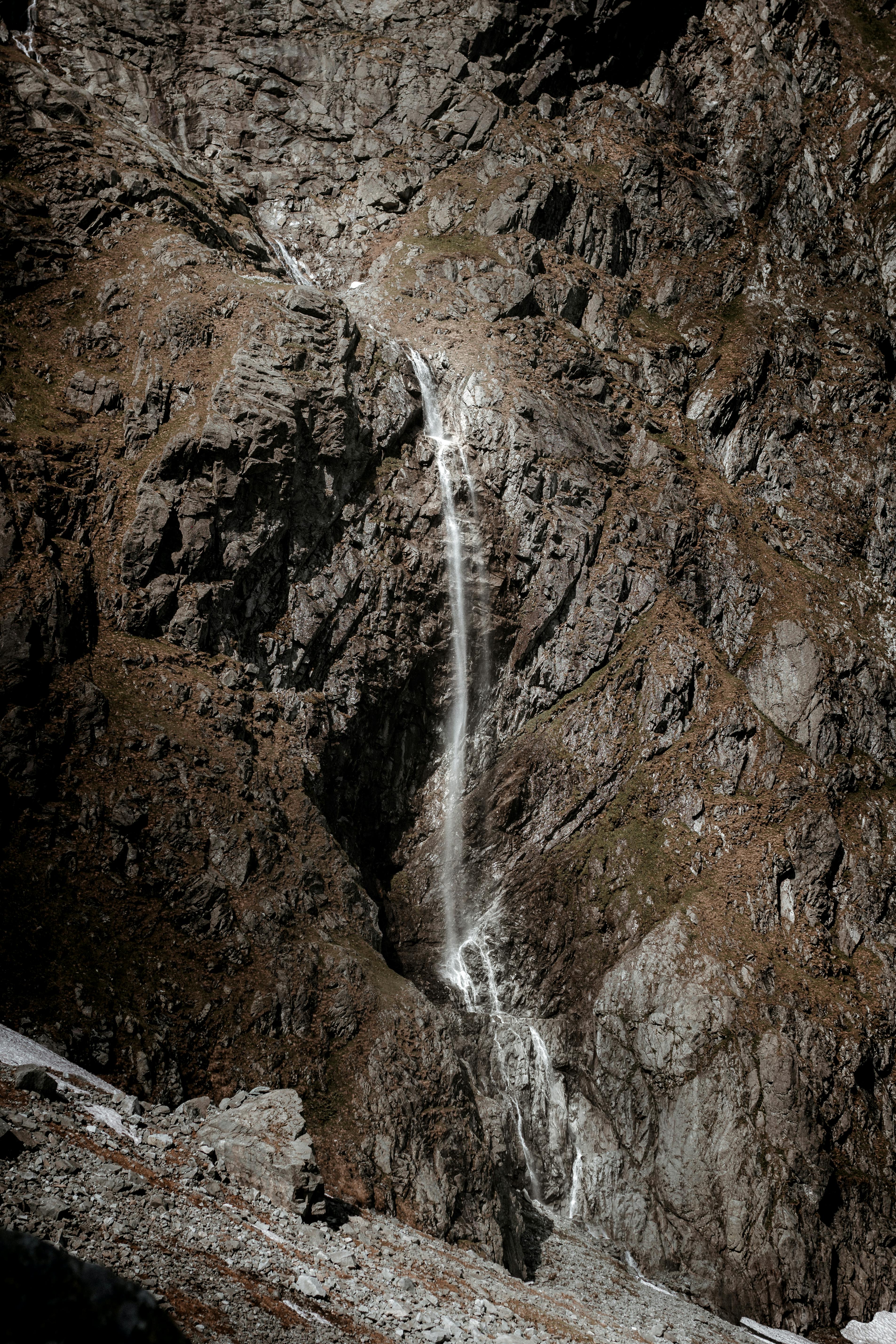 fast cascade on rough mountain in daytime