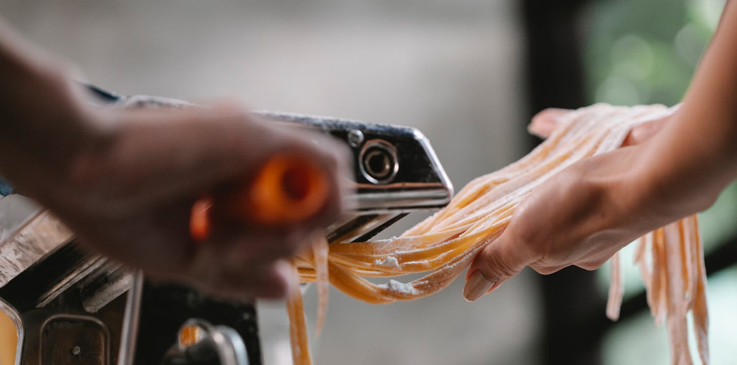 Fresh tagliatelle pasta being made