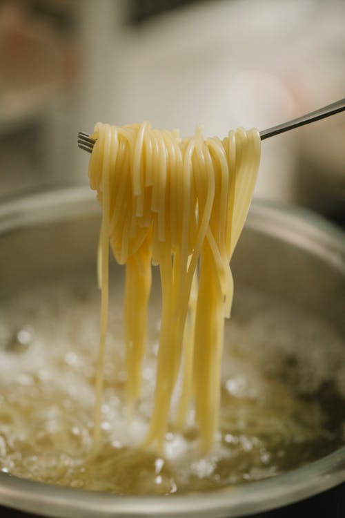 Process of cooking pasta in boiling water in pan
