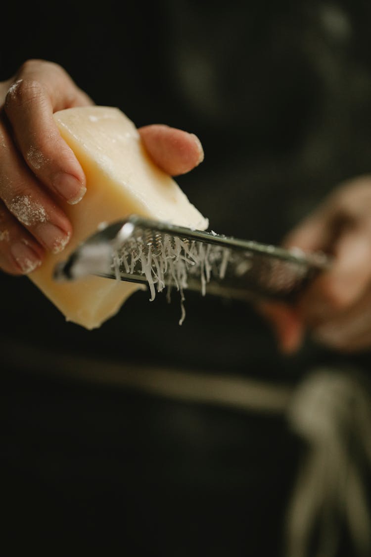 Crop Faceless Housewife Grating Cheese In Kitchen