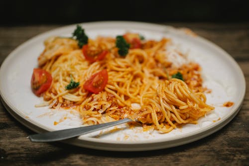 Free Tasty pasta Bolognese and fork served on table Stock Photo