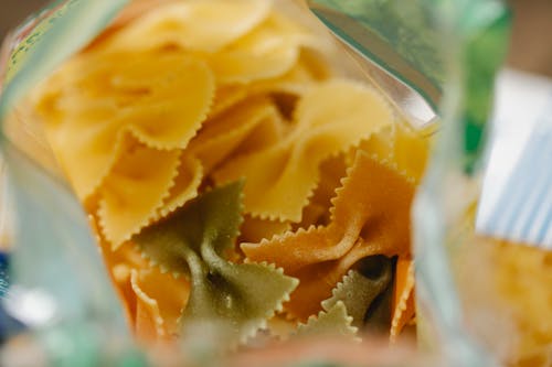 Pack of dry raw farfalle pasta placed on table