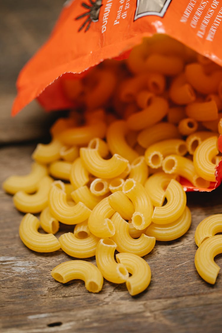 Pack Of Raw Fresh Italian Pasta Scattered On Table