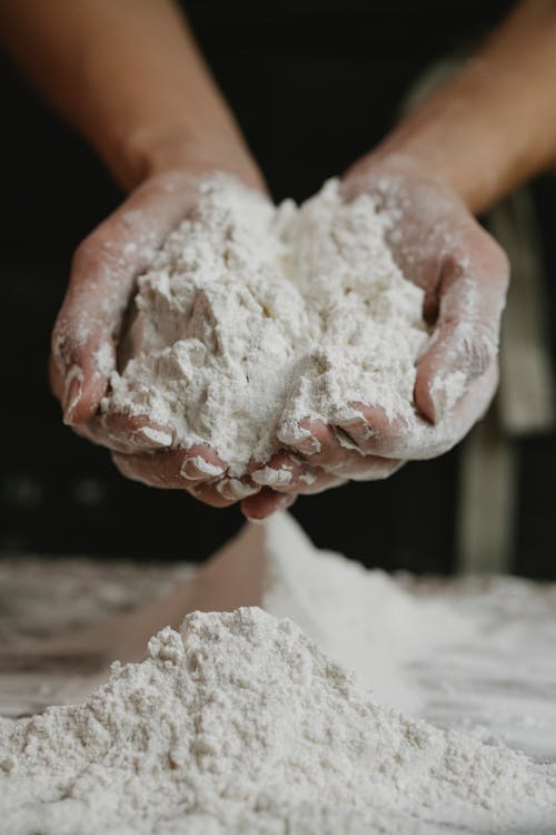 Woman showing wheat flour in hands