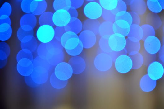 A mesmerizing abstract image with vibrant blue bokeh lights, creating a soothing pattern and mood.