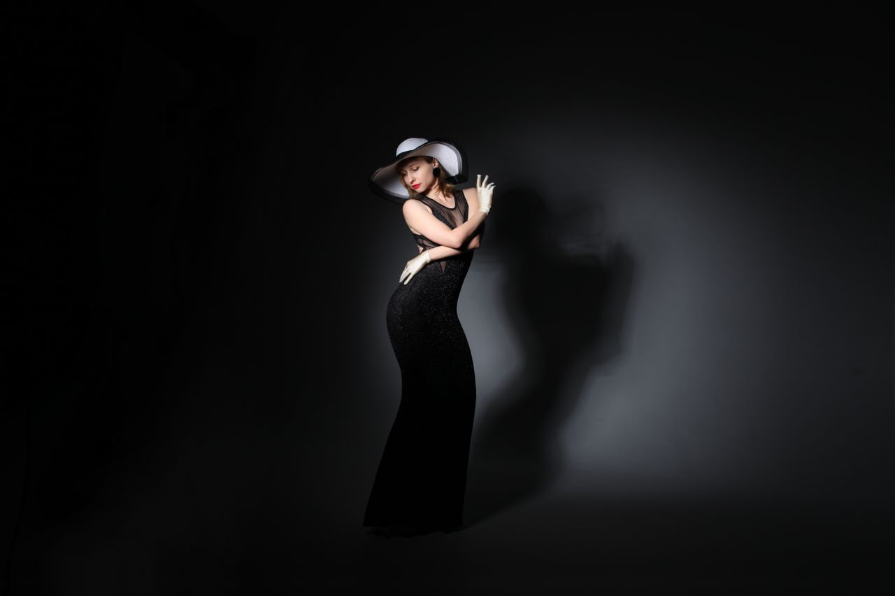 full length of gorgeous young woman in classy maxi dress and hat embra