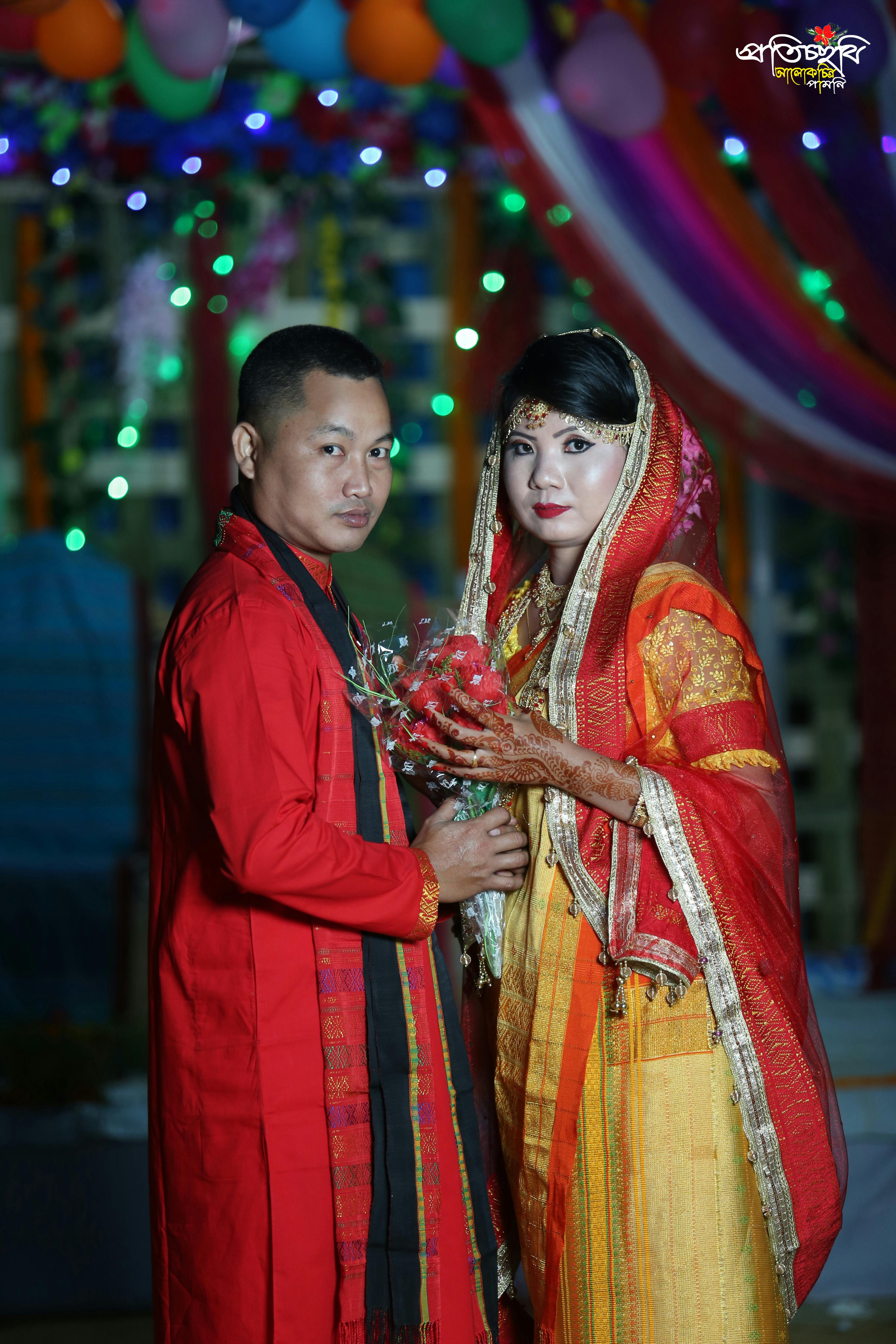 Raw pasta and ingredients like tomatoes, garlic, and herbs laid out on a table