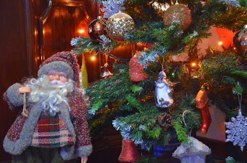 Close-up View of Santa Figurine and Baubles on Tree