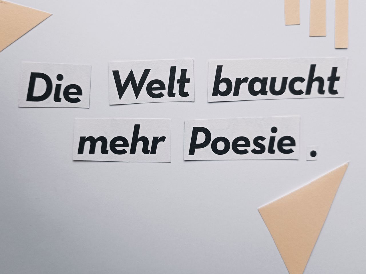 cut out text die welt braucht mehr poesie on a minimalist white backgr