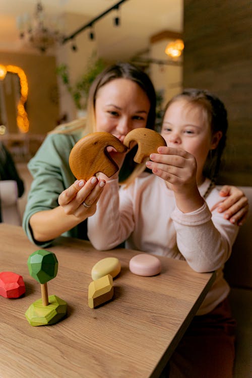 A Woman and Girl Playing a Wooden Elephant