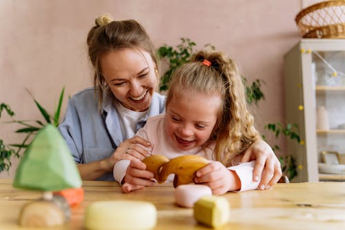 Mother and Daughter Playing with Toys