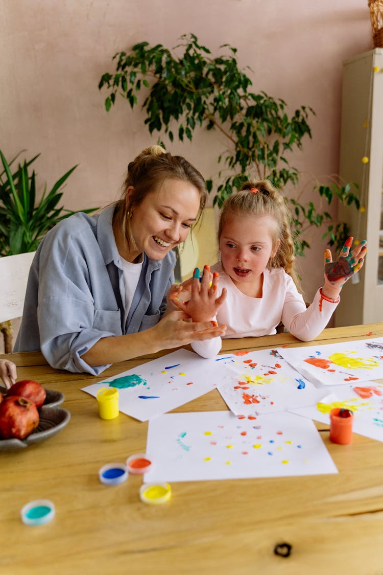 Mother And Daughter Painting Together