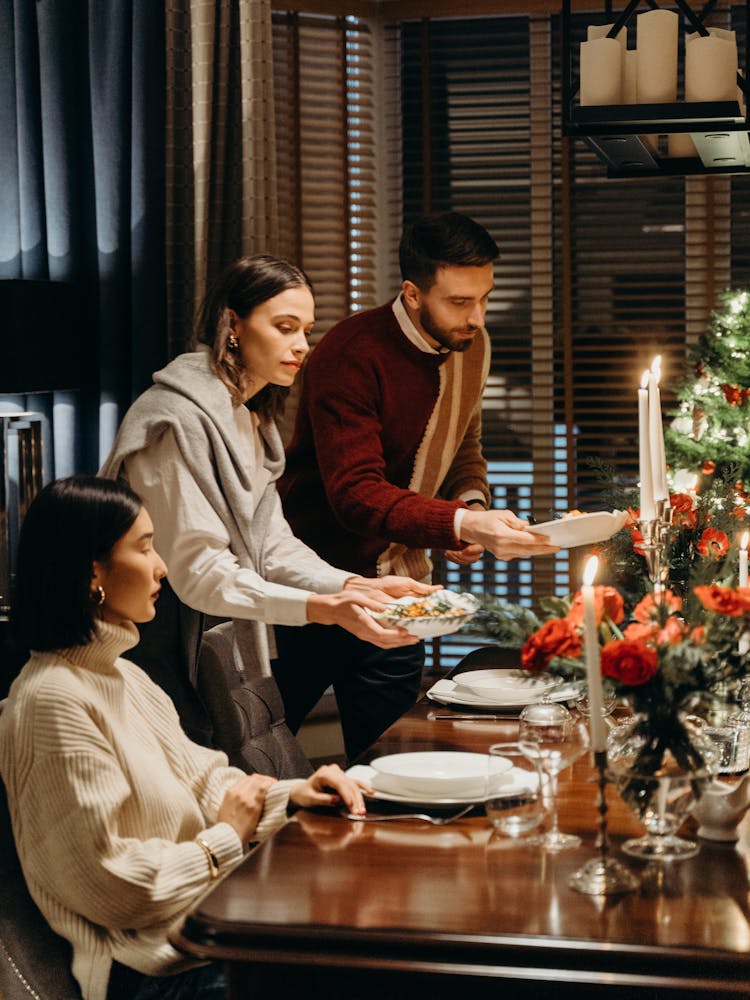 A Woman And Man Serving A Food 