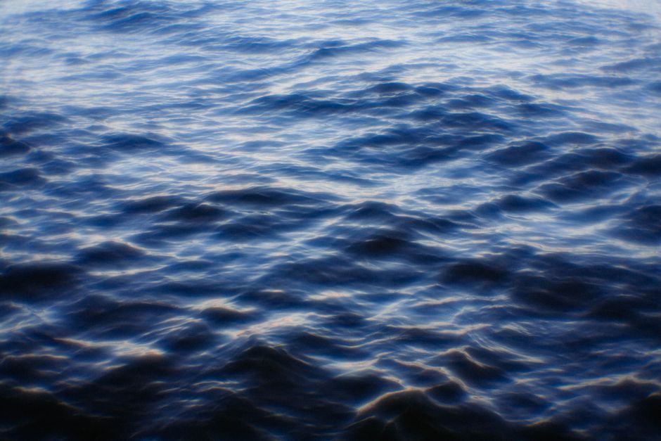 A serene view of deep blue ocean waves gently rippling on the surface.
