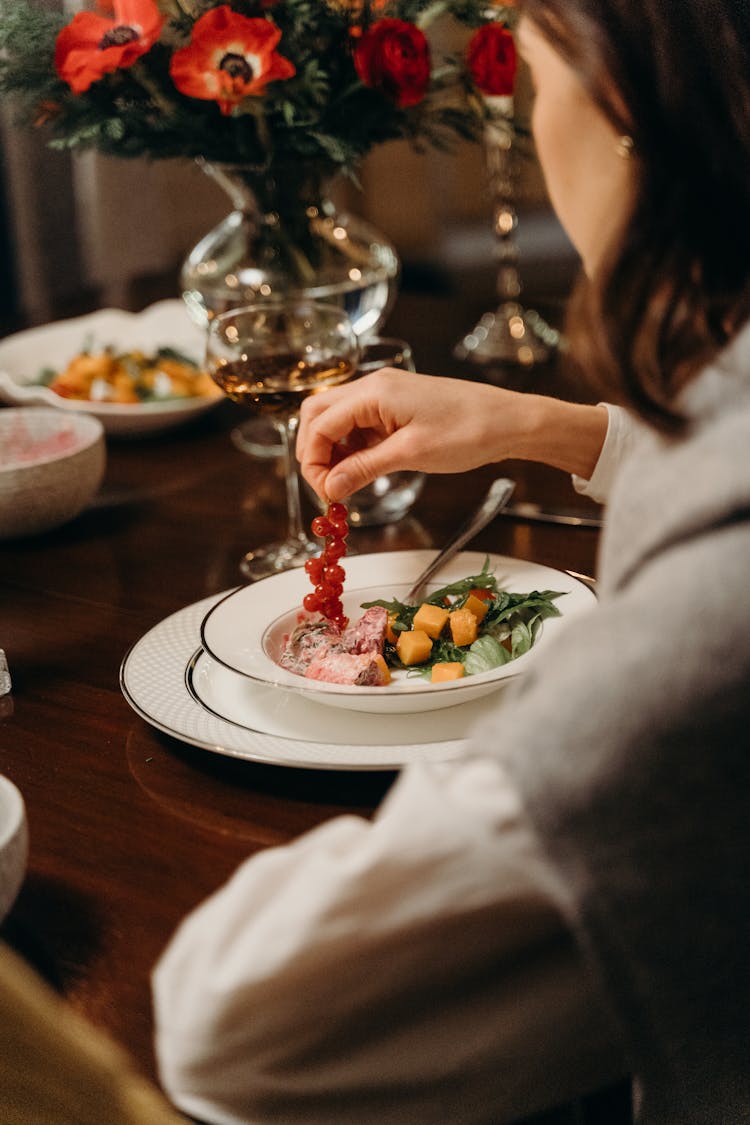 Over Shoulder Shot Of A Woman Eating Food 