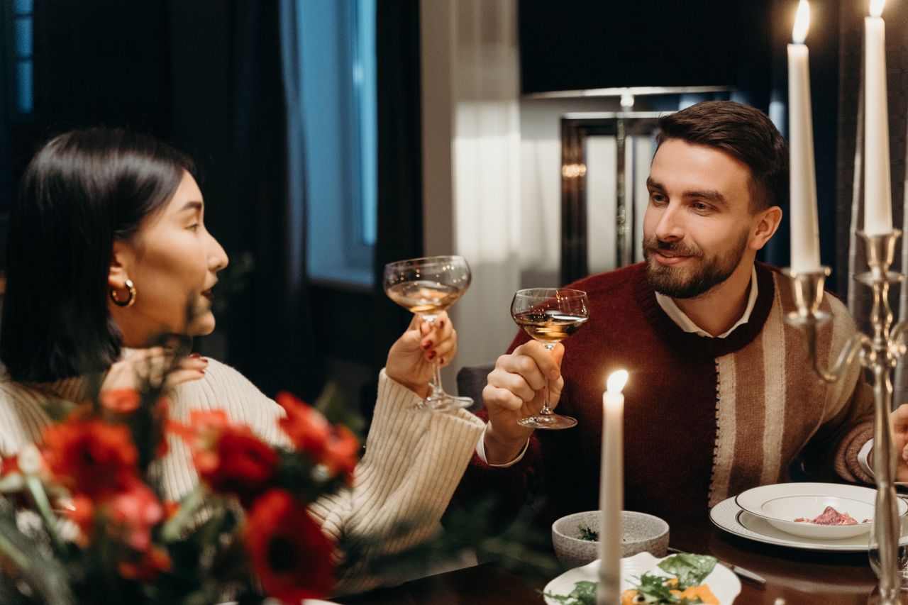 A couple enjoying a romantic dinner with candles