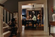 Cozy family moment at home with a Christmas tree, showing warmth and togetherness.