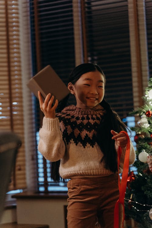 Smiling Girl Holding a Gift