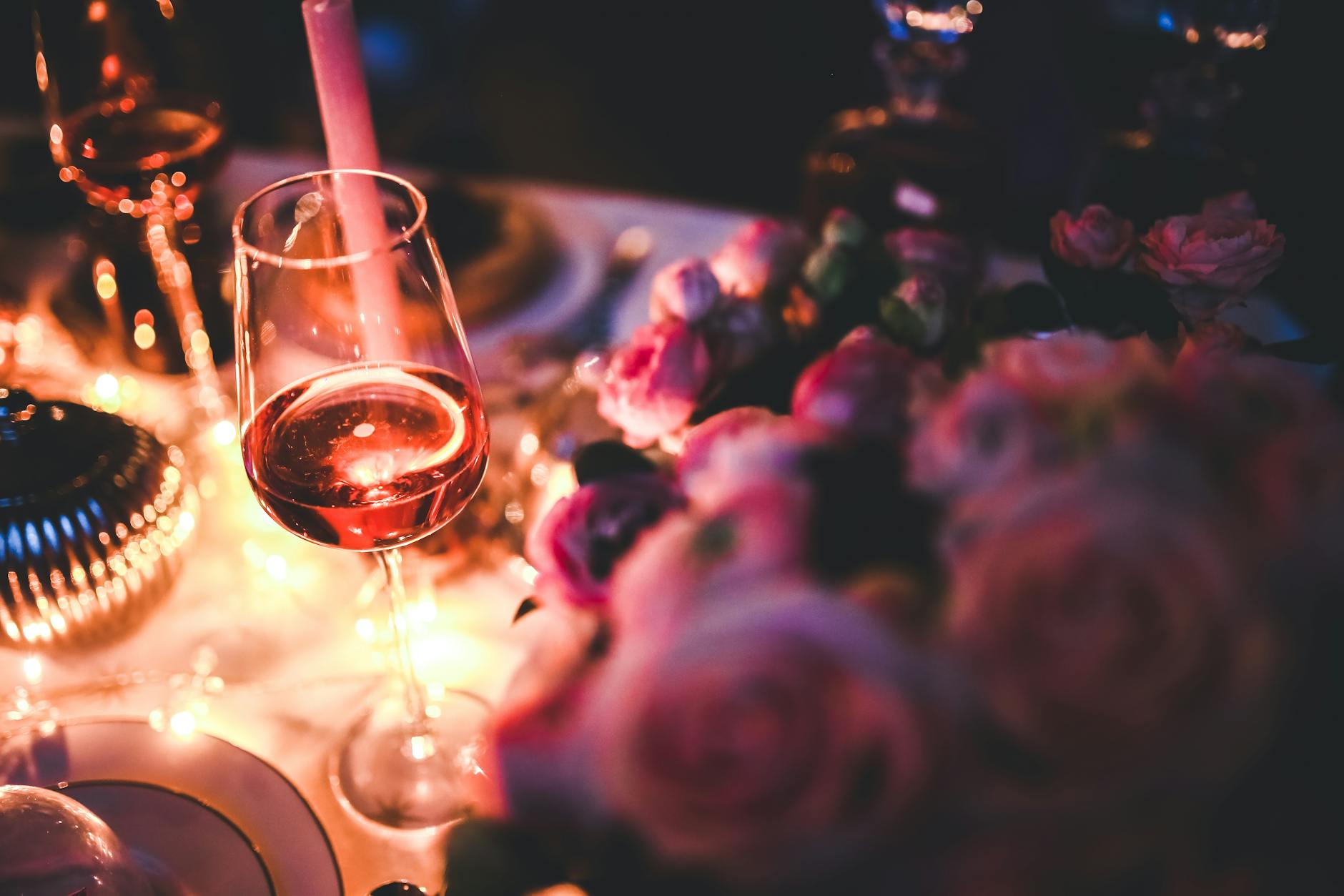 A glass of wine and roses