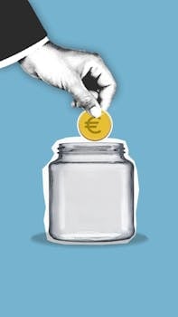 A conceptual image of saving money with a euro coin being placed into a glass jar on a blue background.