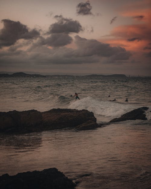 People Surfing on Sea Waves