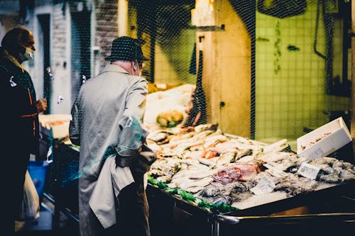 Free Man Buying Seafood on a Fish Stall in the Market Stock Photo