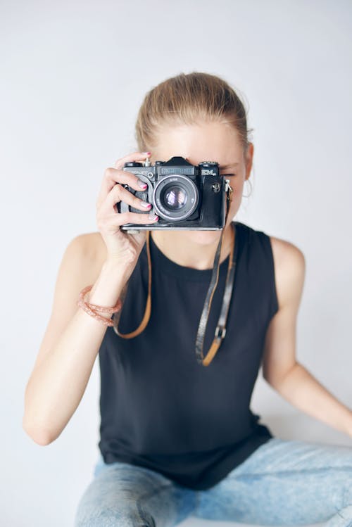 Woman Taking Pictures with a Camera with One Hand