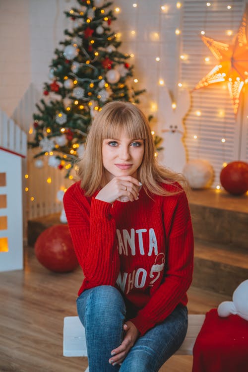 Content woman in room with Christmas tree