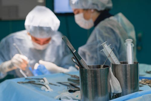 Free Medical Instruments and a Surgeon During a Surgery  Stock Photo