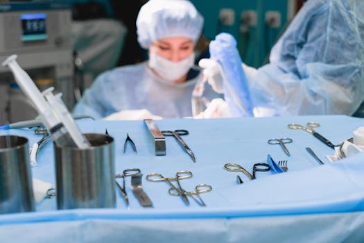 Close-up view of surgical instruments on a table during a medical operation in a hospital.
