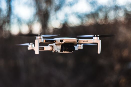 A detailed image of a drone in mid-flight with a blurred background.