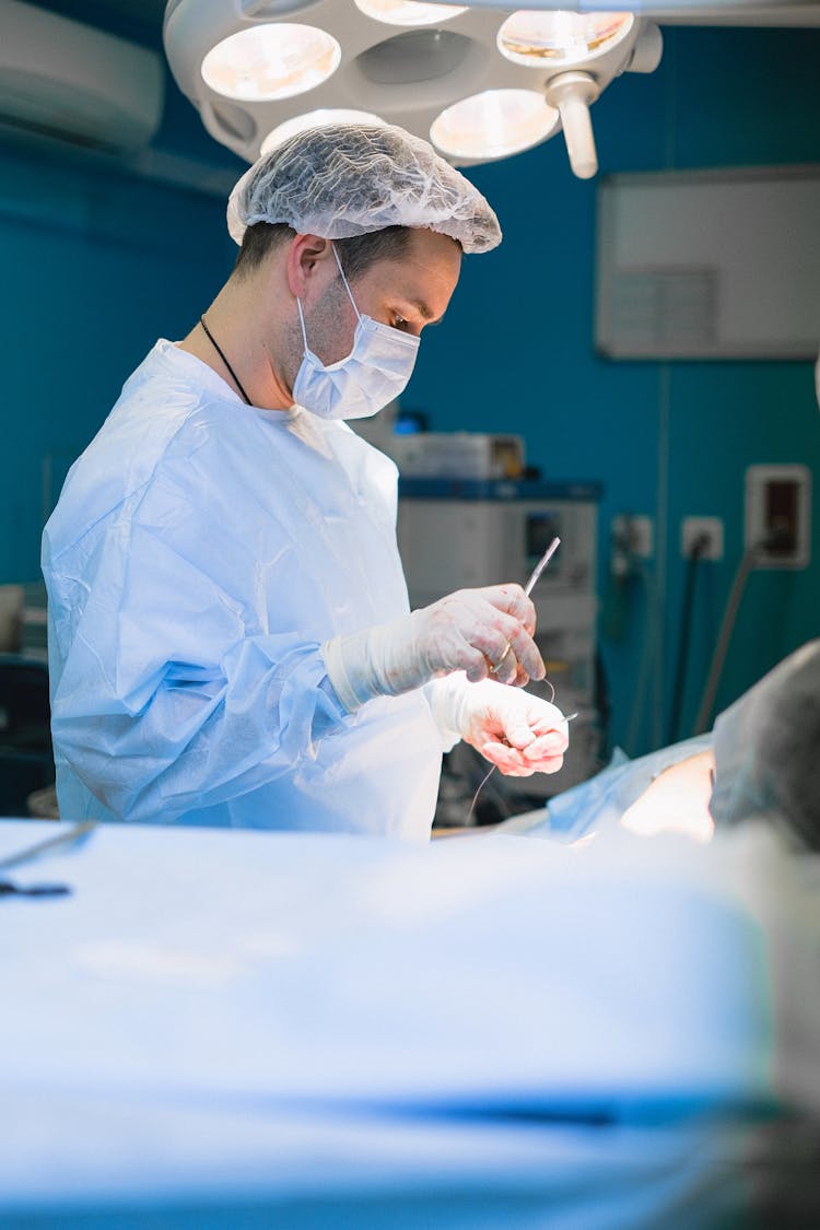 Surgeon Performing A Surgery In An Operating Room 