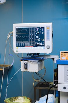 Close-up of a hospital monitor displaying vital signs and heart rate data.
