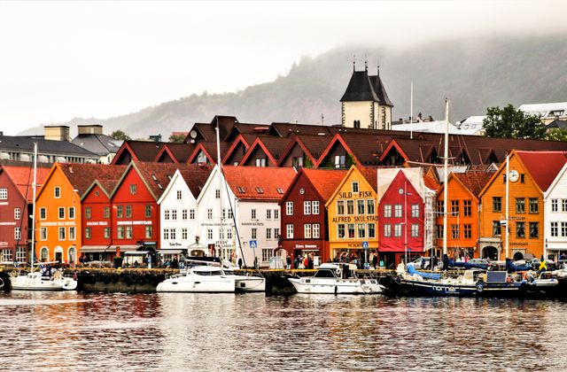 Charming waterfront of Bergen showcasing vibrant historic buildings and boats. — arriving in Bergen