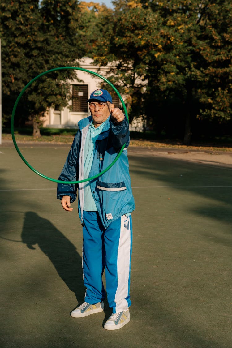 Man In Blue Tracksuit Using A Hula  Hoop