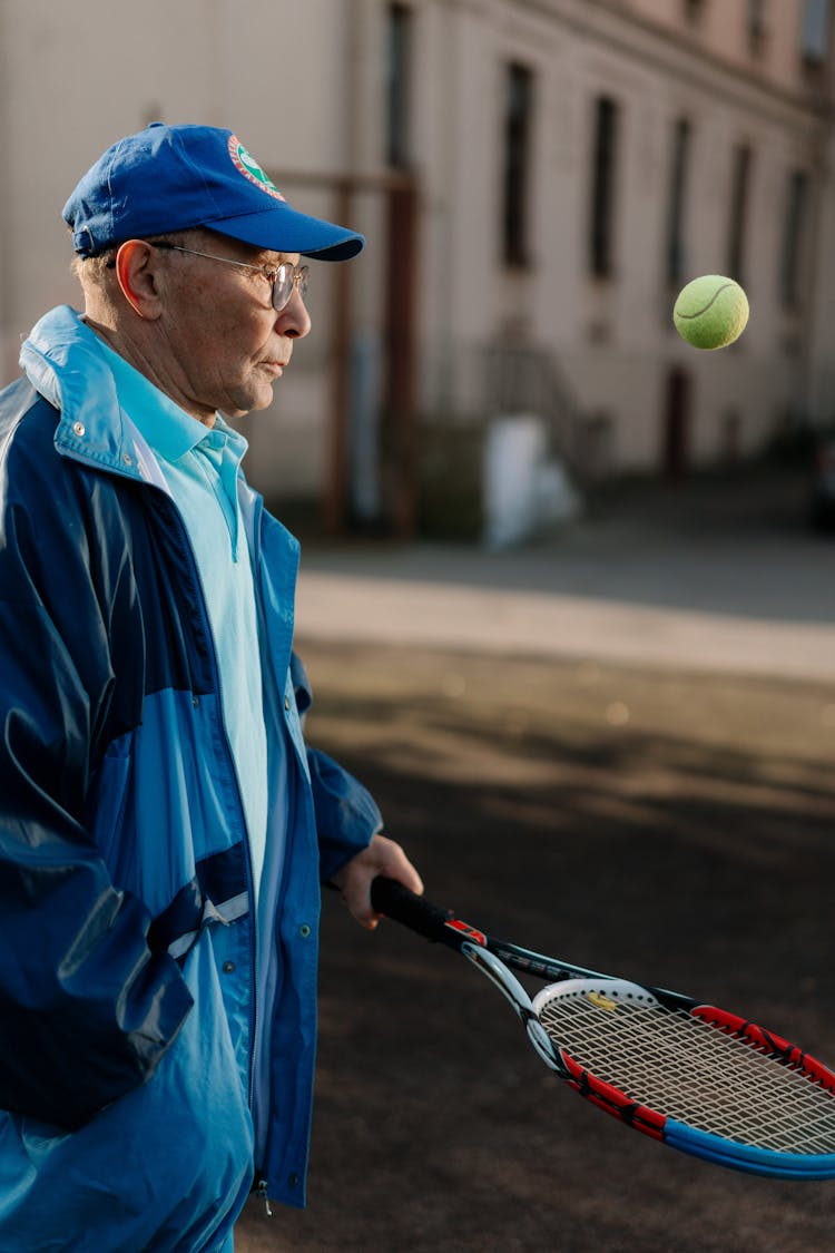 Man In Blue Jacket Playing Tennis