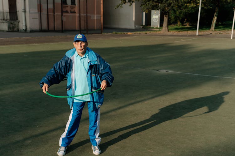 An Elderly Man Using A Hula Hoop