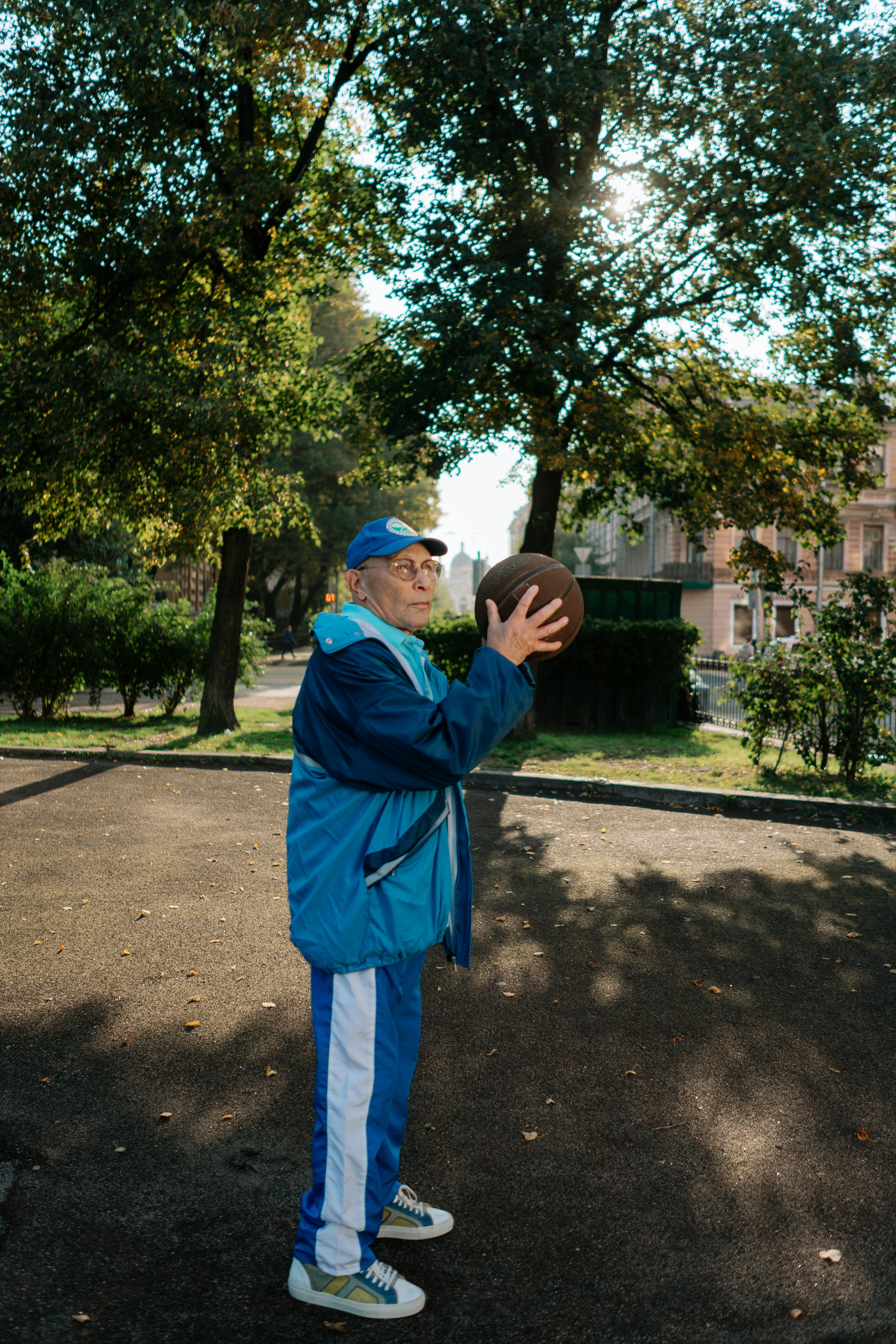 an elderly man holding a ball