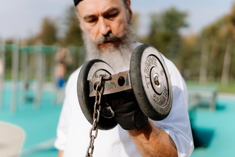 Elderly Man Lifting A Dumbbell