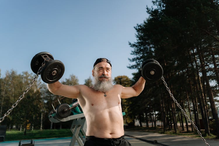 Shirtless Man Lifting Dumbbells