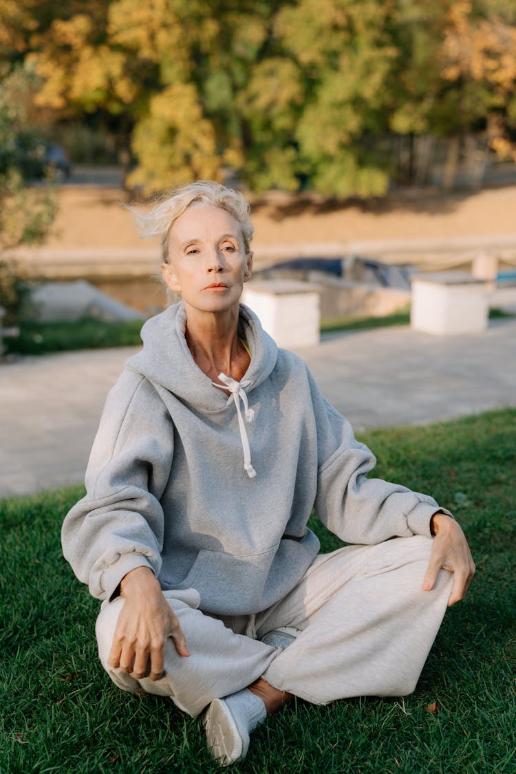 Mature Woman Sitting On Grass