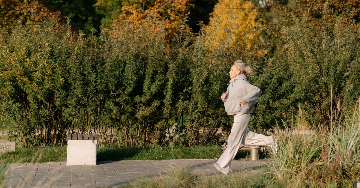 elderly person hiking outdoors looking healthy and energetic