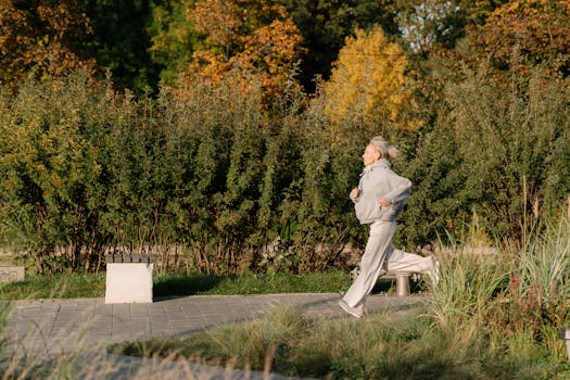 Elderly woman enjoying a healthy jog in a scenic park, showcasing active lifestyle.
