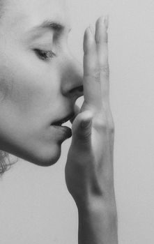 Artistic monochrome side profile of a woman in an introspective pose, Kyiv, Ukraine.