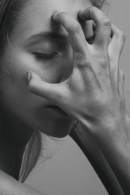 A Woman Covering Her Face with Her Hands