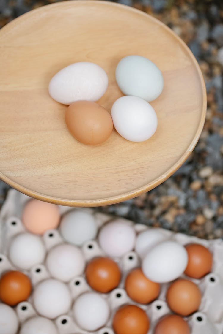 Chicken Eggs On Wooden Board And In Carton Container