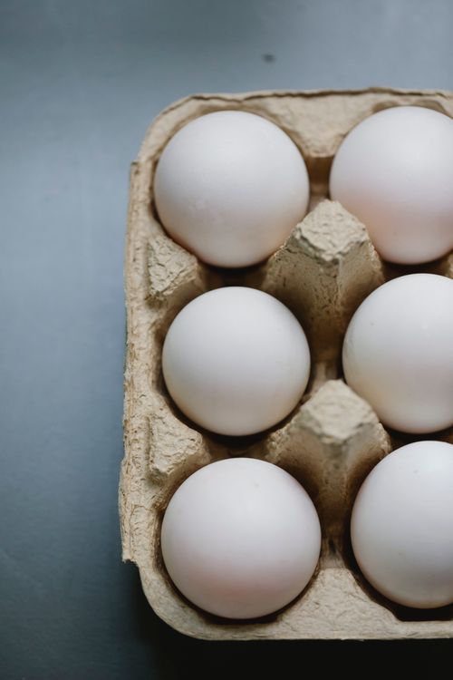 Free From above of chicken eggs placed in carton container placed on table for cooking Stock Photo