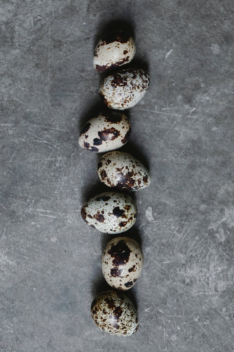 Raw Quail Eggs Scattered On Table