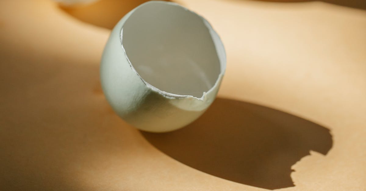 White eggshell placed on table in kitchen in sunny morning