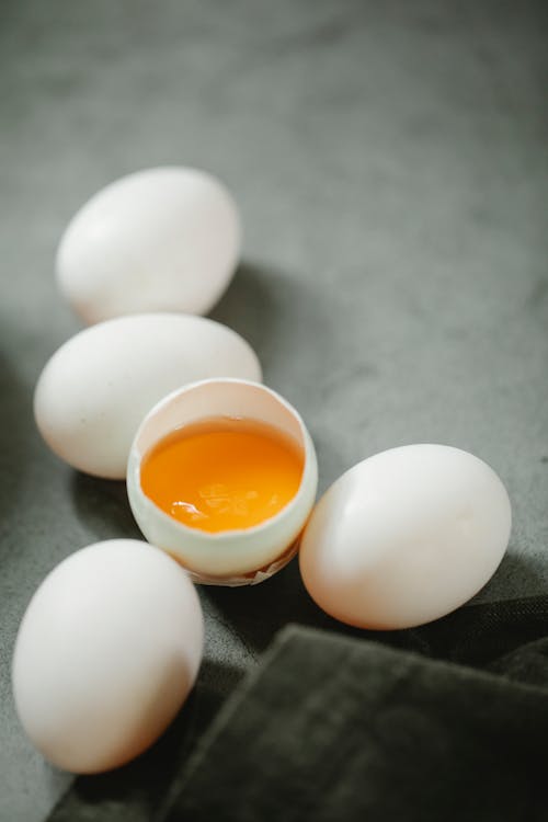 Raw egg placed on table near black towel